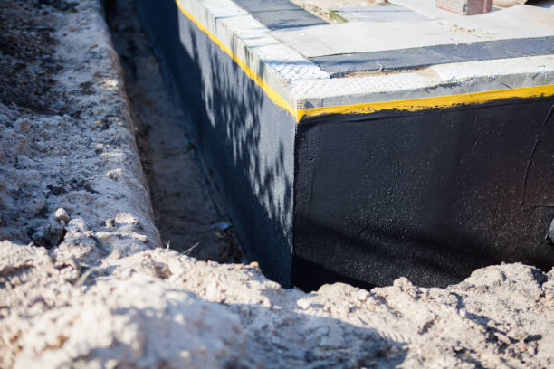 Professional Basement Waterproofing technician working in Westwood, KY